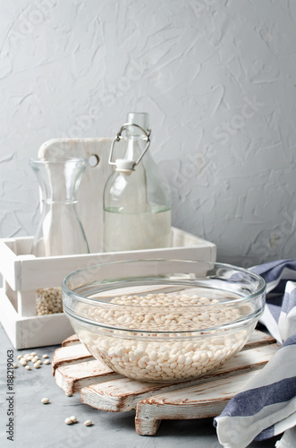 Obraz na plátně White beans soaked in water in a glass bowl