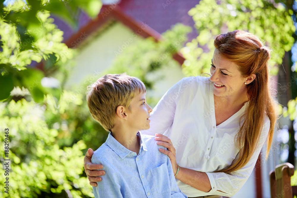 happy mother and son at summer garden happy mother and son at summer garden