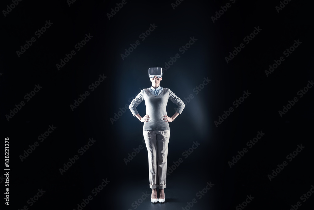 3d dimension. Positive cheerful nice woman standing against black background and looking up while being in 3d dimension
