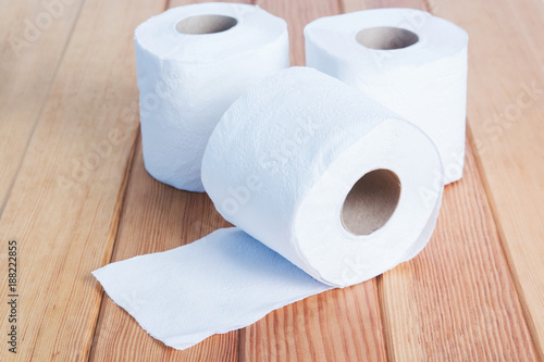White toilet tissue roll on wood.