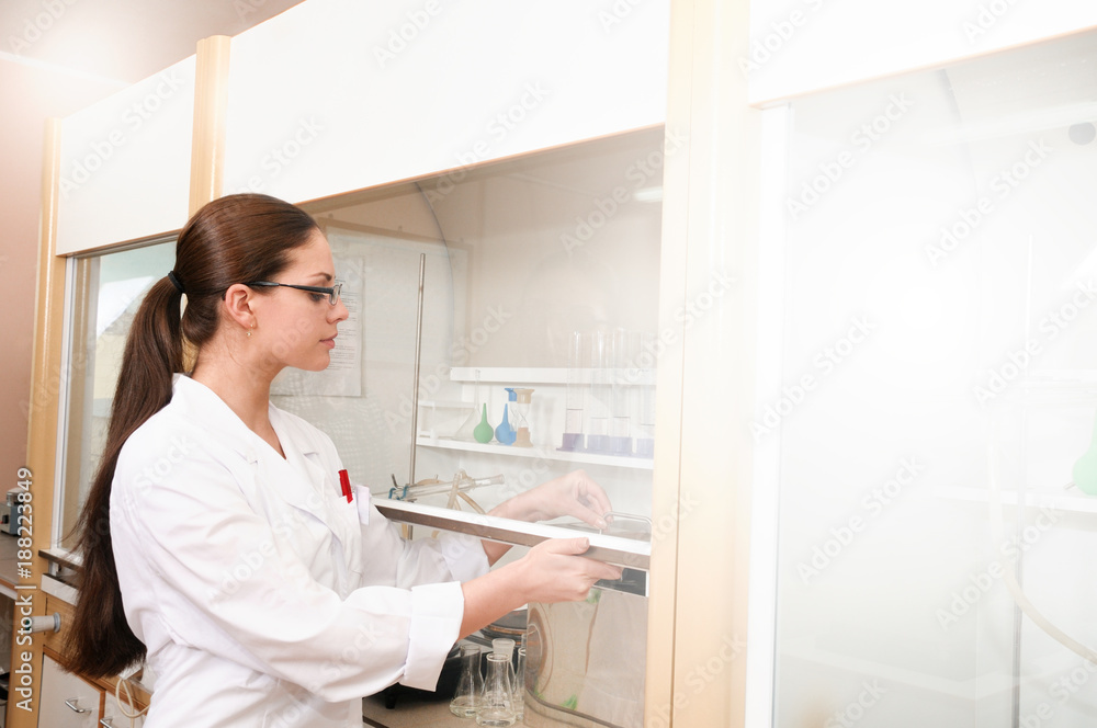 Young woman sciencist in laboratory near equipment Young woman sciencist in laboratory near equipment