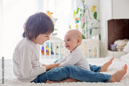 Photos Little toddler boy, playing with his little brother at home