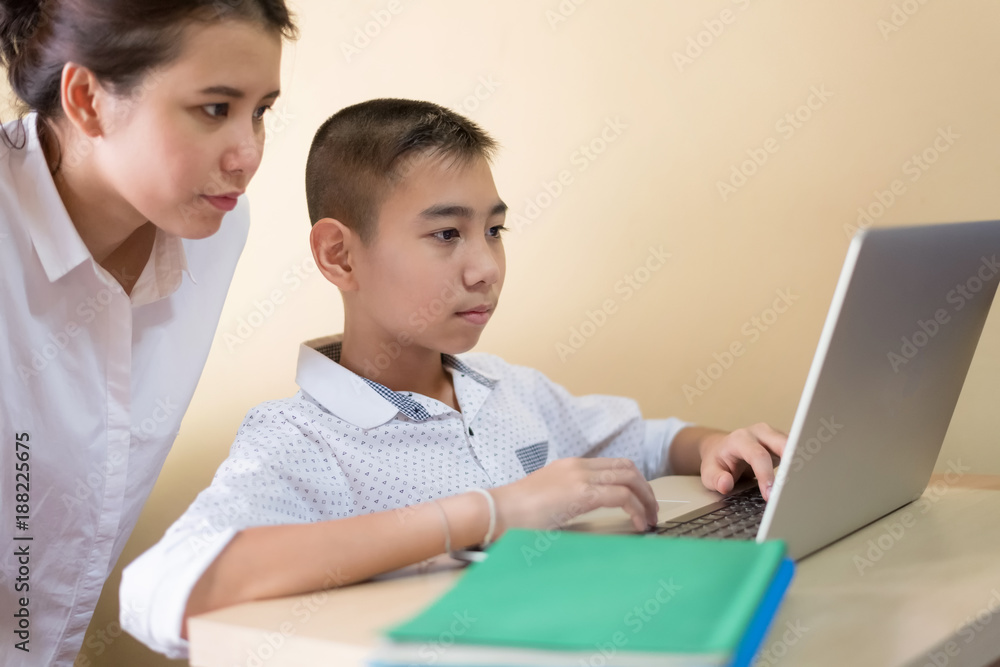 Young boy student, studying computer and is happy to learn new things new Young boy student, studying computer and is happy to learn new things new