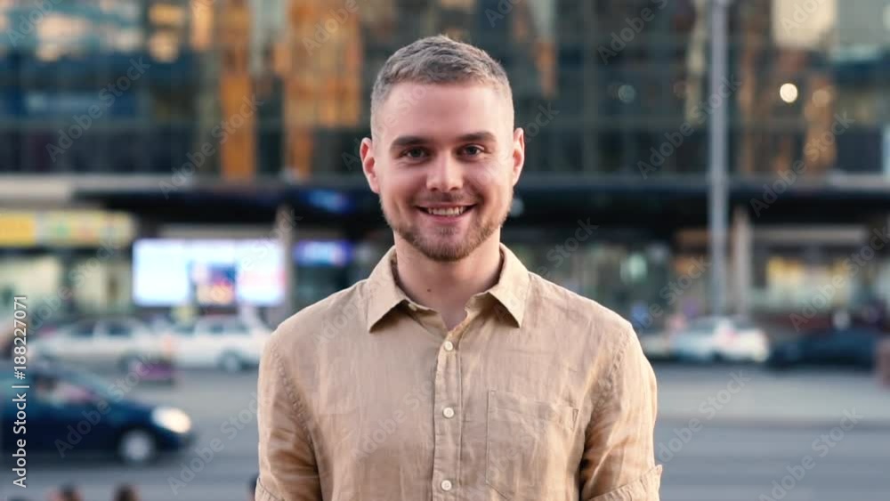 Slow Motion Portrait of happy cute caucasian man smiling in city Slow Motion Portrait of happy cute caucasian man smiling in city