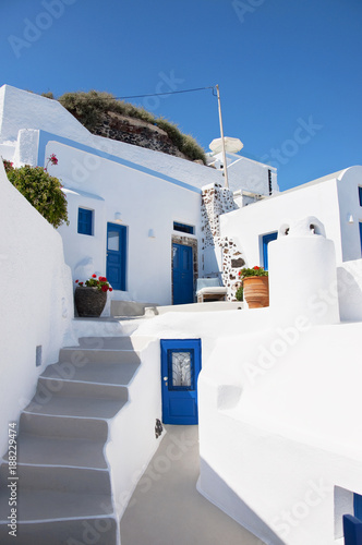Santorini Island, Greece, Europe. Traditional white Greek architecture over Caldera, a beautiful landscape with a blue sky and famous white houses.