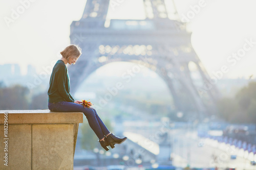 Beautiful young French woman near the Eiffel tower in Paris