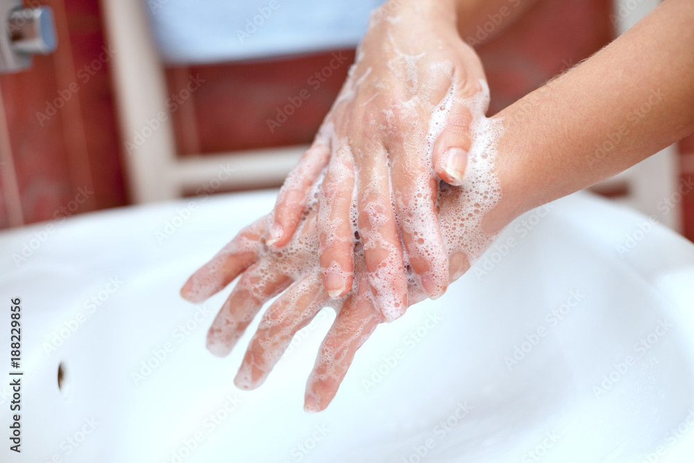 Soapy hands cleaning above the sink Soapy hands cleaning above the sink
