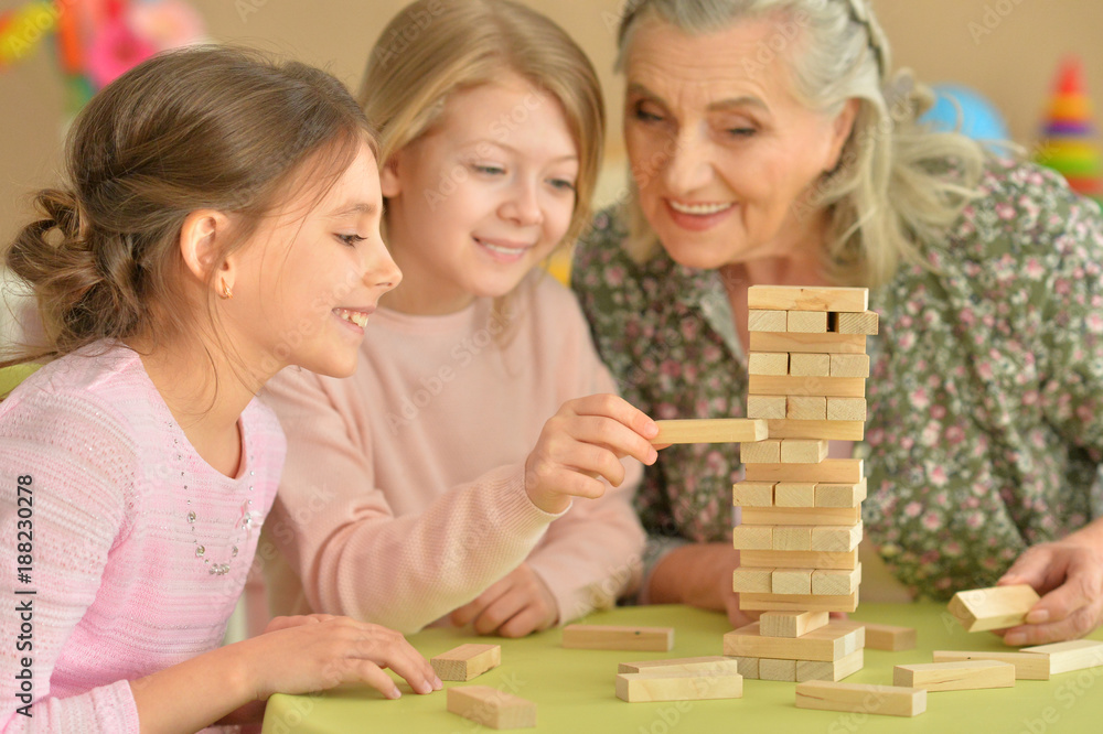 girls and grandmother playing with blocks girls and grandmother playing with blocks