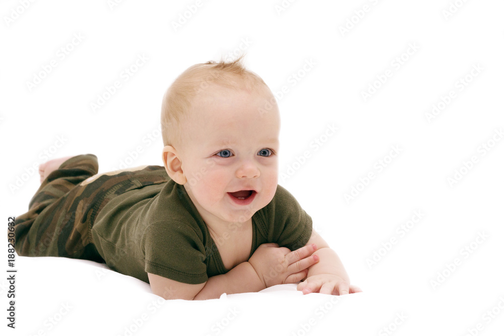 Funny laughing baby boy crawling on the white blanket against isolated white background Funny laughing baby boy crawling on the white blanket against isolated white background
