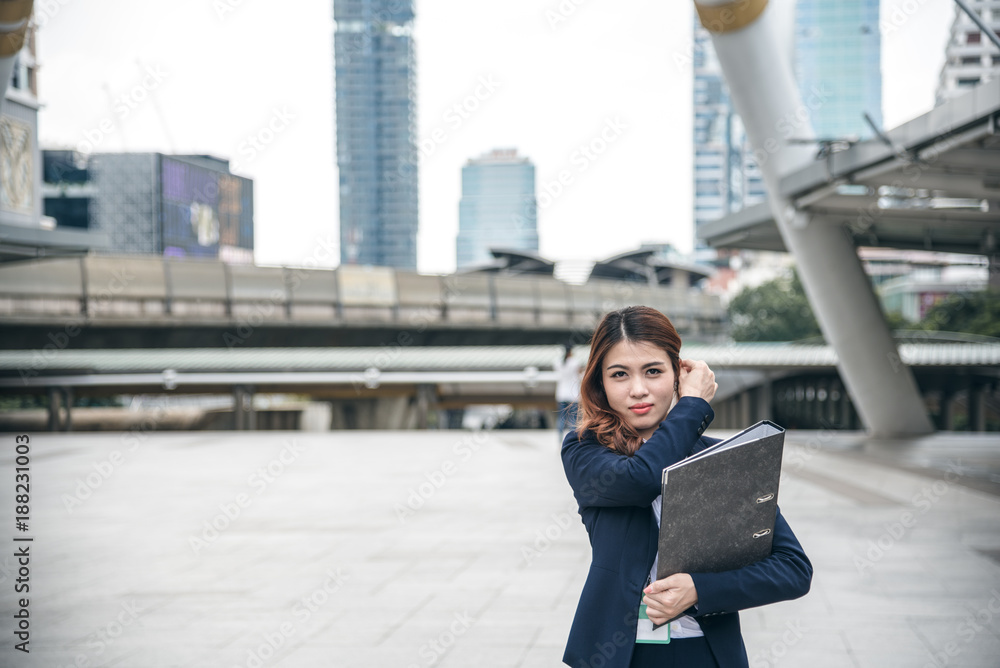 Portraits of beautiful asian woman look cheerful and confidence is standing in outdoors while feeling success with work.