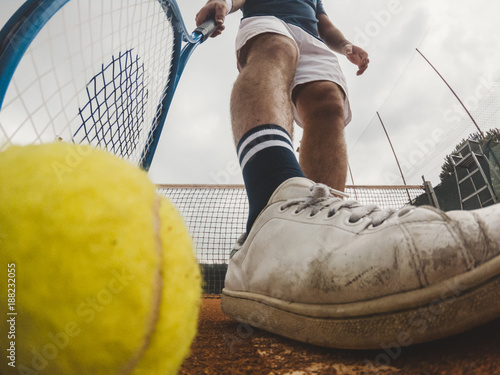 Detail of the grip of a ball during a tennis match on a clay court