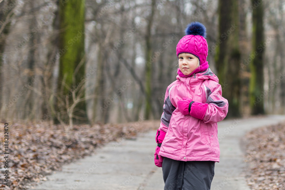 Little girl walking alone in a forest at autumn Little girl walking alone in a forest at autumn