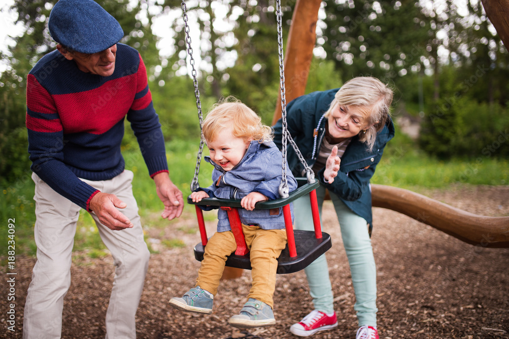 Senior couple with little boy at the playground. Senior couple with little boy at the playground.