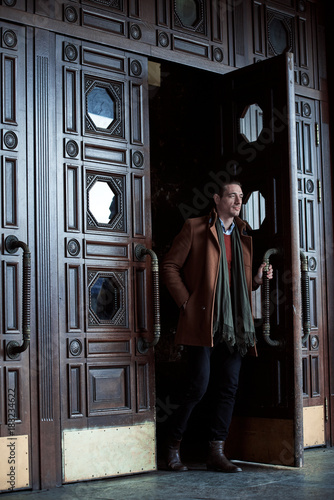 Full length portrait of serene man walking out the door