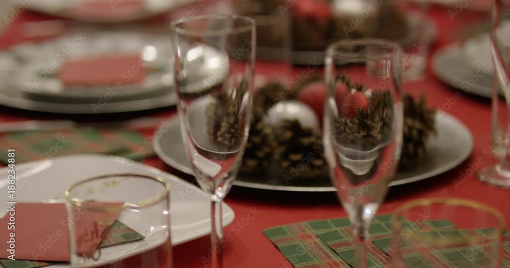 Christmas dinner place setting - rack focus on champagne glasses Christmas dinner place setting - rack focus on champagne glasses