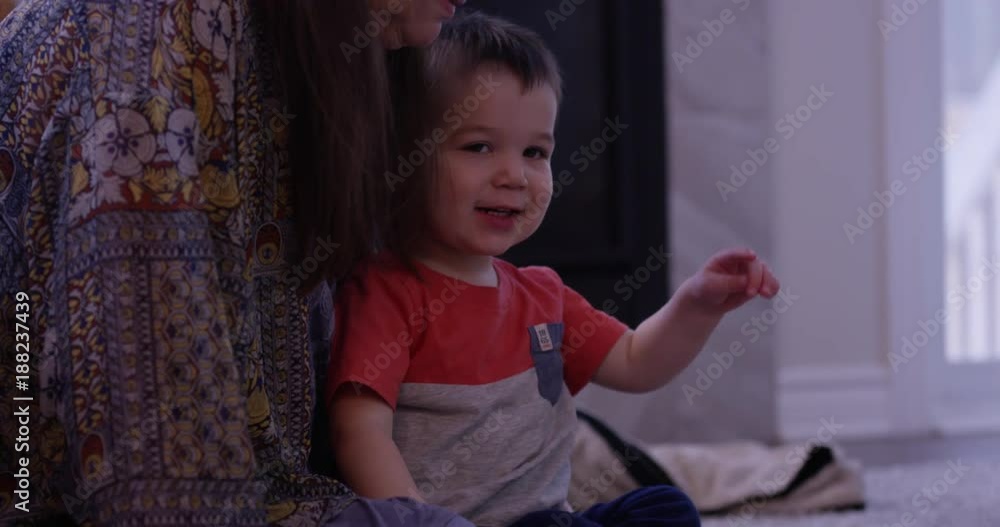 Grandmother sits on toddlers lap - happy family Grandmother sits on toddlers lap - happy family
