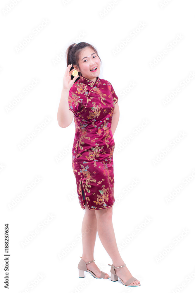 Beautiful Young asian woman wearing chinese dress traditional cheongsam or qipao with hand holding golden Bitcoin isolated on white background. Chinese New Year Festivities, Electronic money concept Beautiful Young asian woman wearing chinese dress traditional cheongsam or qipao with hand holding golden Bitcoin isolated on white background. Chinese New Year Festivities, Electronic money concept