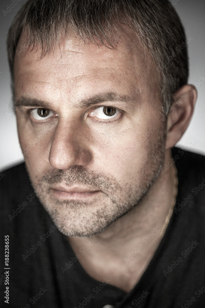 A man with a stubble on his face in the twilight A man with a stubble on his face in the twilight