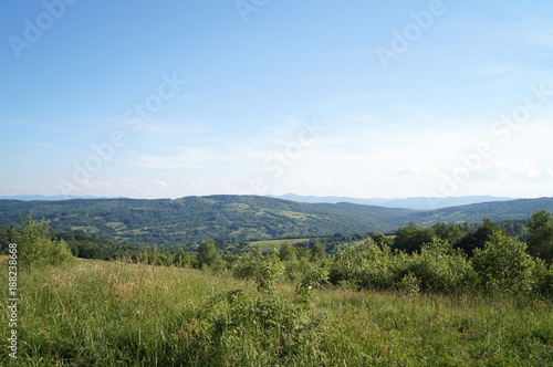 A view of the Carpathian mountains under the blue sky and white clouds