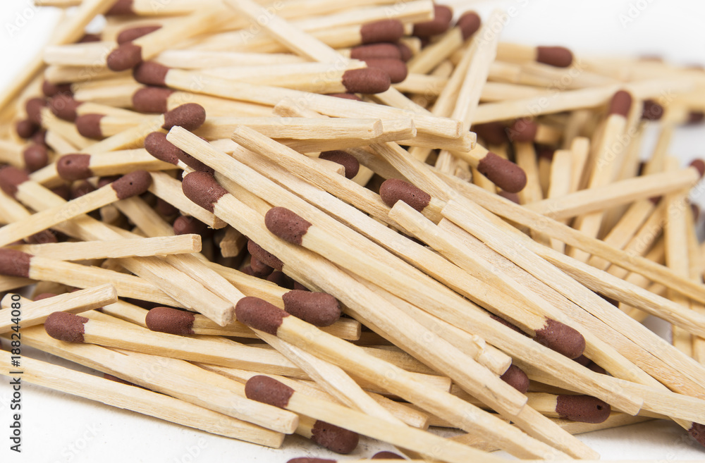 Match sticks with brown heads in stacks .  Matches texture background