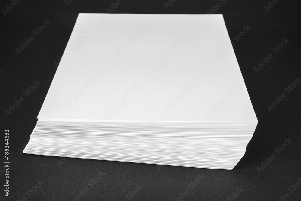 New unused office paper on black background New unused office paper on black background