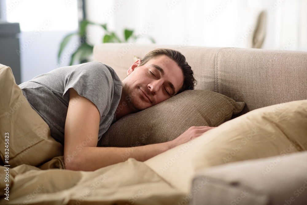 Sweet dreams. Calm man sleeping on bed. His eyes are closed with peace Sweet dreams. Calm man sleeping on bed. His eyes are closed with peace