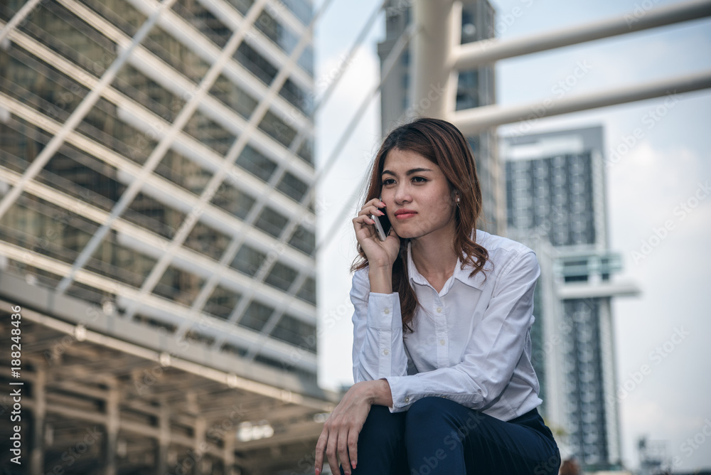 Portraits of beautiful asian woman look confidence is standing and holding cellphone . she using smartphone calling to conversation with customer. Portraits of beautiful asian woman look confidence is standing and holding cellphone . she using smartphone calling to conversation with customer.
