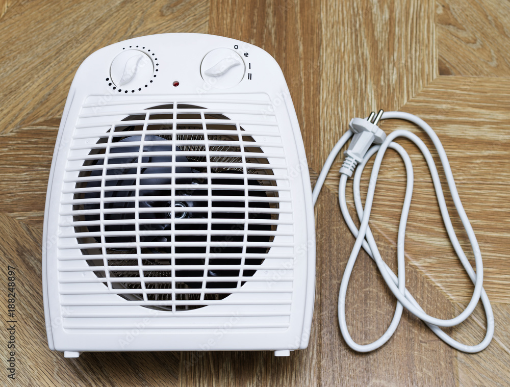 Modern electric fan heater at home. Stock Photo | Adobe Stock