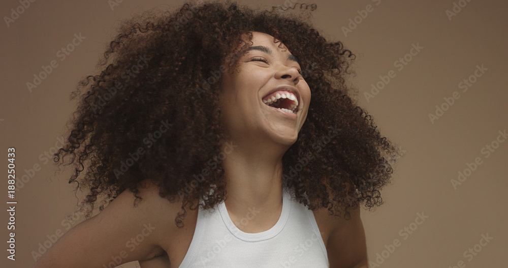 mixed race black woman portrait with big afro hair, curly hair in beige  background. Natural laughing Stock Photo | Adobe Stock