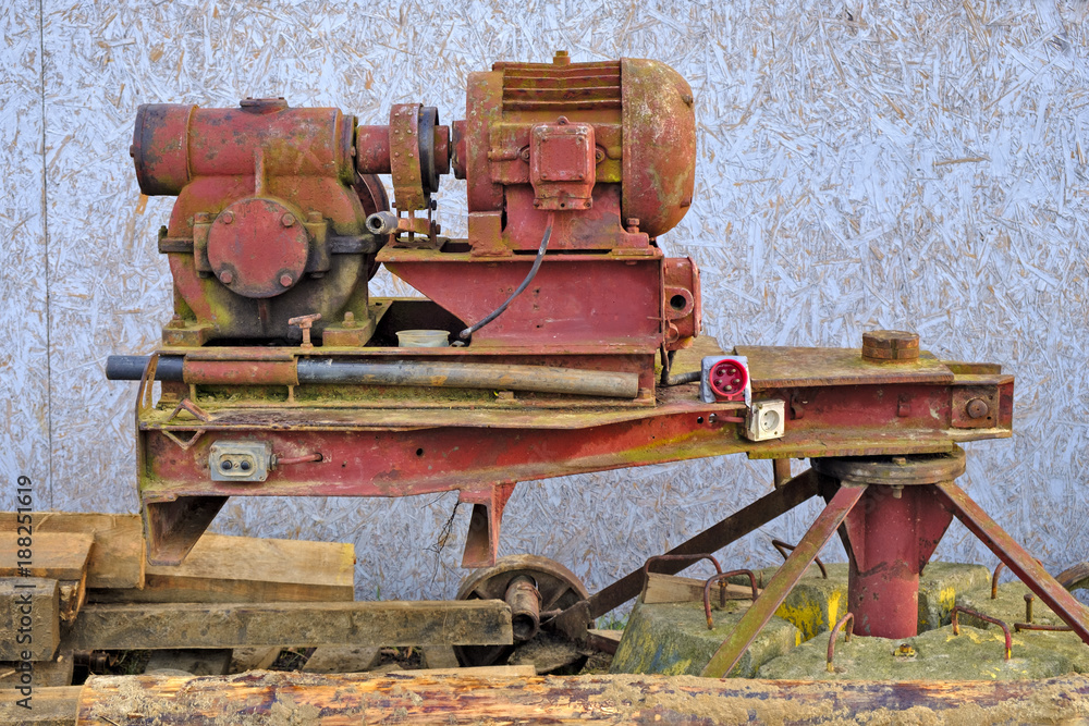 Worn vintage electric power machinery on a massive platform in construction site