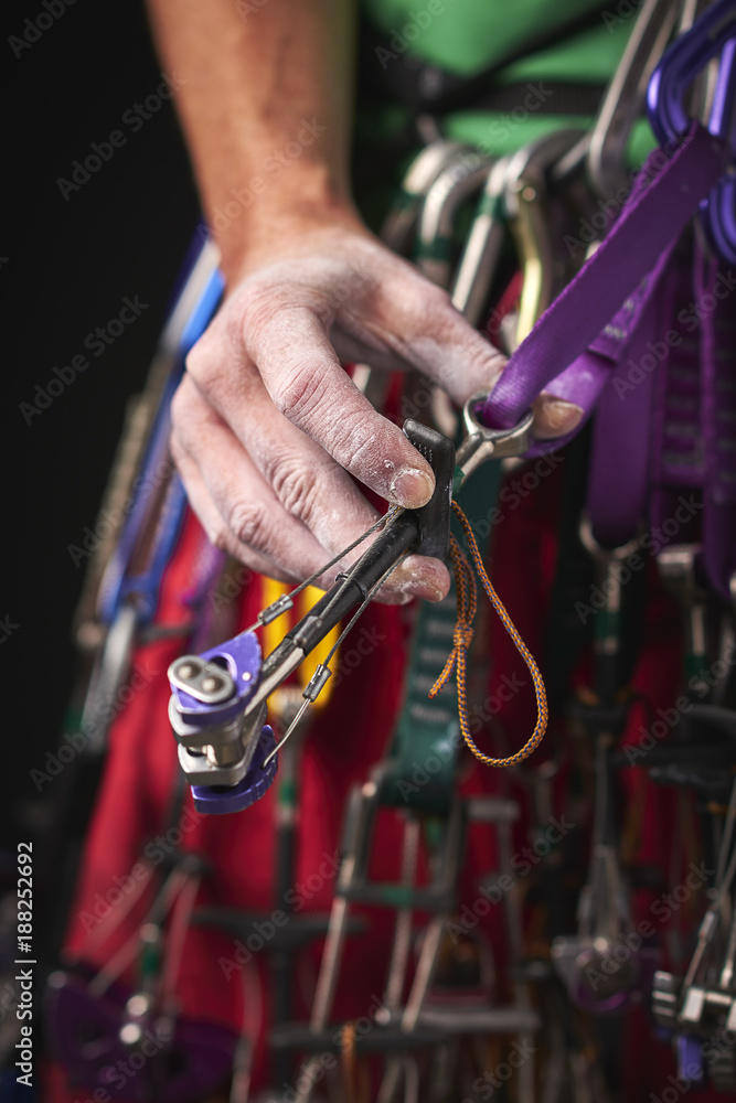 a woman using climbing gear a woman using climbing gear