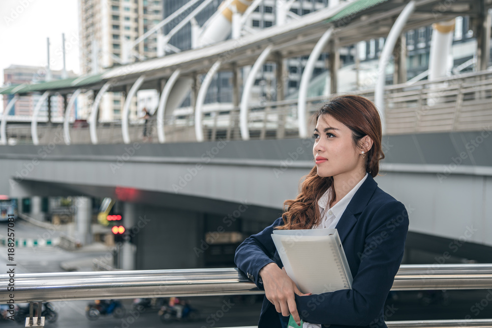 Portraits of beautiful asian woman look cheerful and confidence is standing in outdoors while feeling success with work. Portraits of beautiful asian woman look cheerful and confidence is standing in outdoors while feeling success with work.