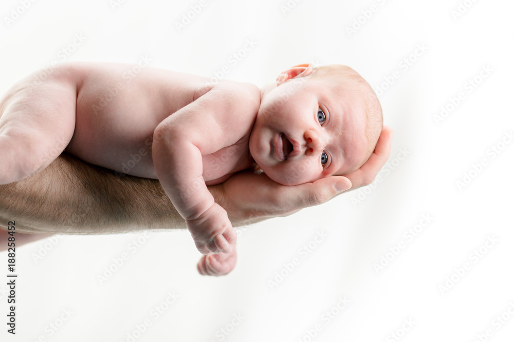 Newborn Baby in hands of dad - happy family moments of parents with their children. Beautiful time in life. Newborn Baby in hands of dad - happy family moments of parents with their children. Beautiful time in life.