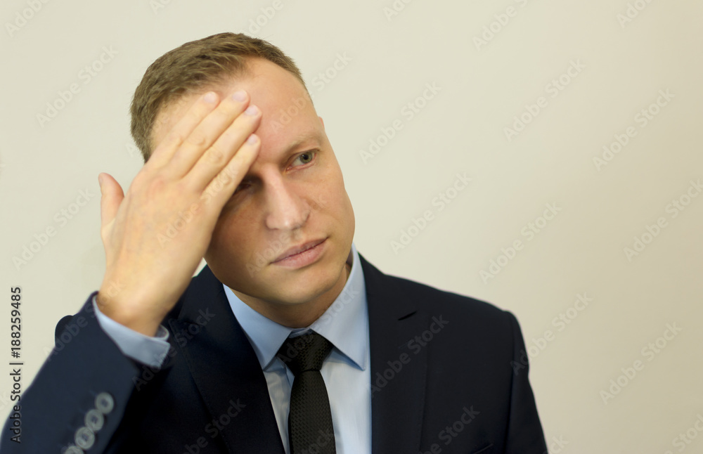 Handsome man in suit posing and looking with hand on head Handsome man in suit posing and looking with hand on head