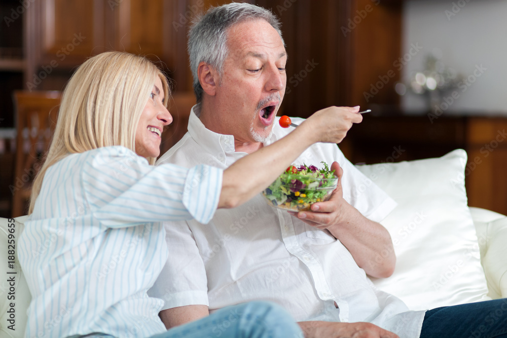 Healthy senior couple eating salad