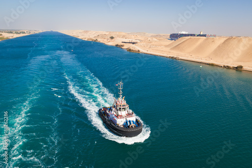 Tugboat behind a cruise ship on Suez canal, Egypt