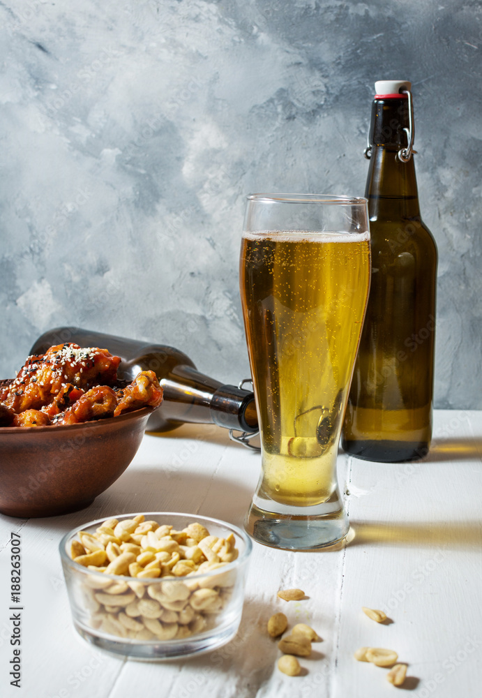 Buffalo style chicken wings served with cold beer Buffalo style chicken wings served with cold beer
