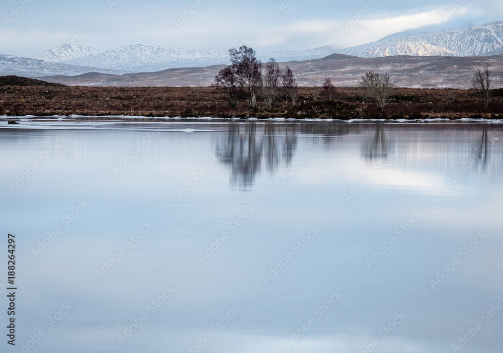 landscape view of scotland and a frozen lochan near glen coe in the remote highlands in scotland