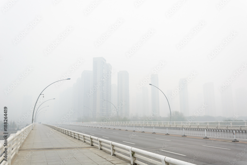 City in a heavy hazy weather. The deterioration of air quality resulted in low horizontal visibility. Located in Sanhao Bridge, Shenyang, Liaoning, China.