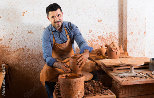 Fototapeta Mature man making pot