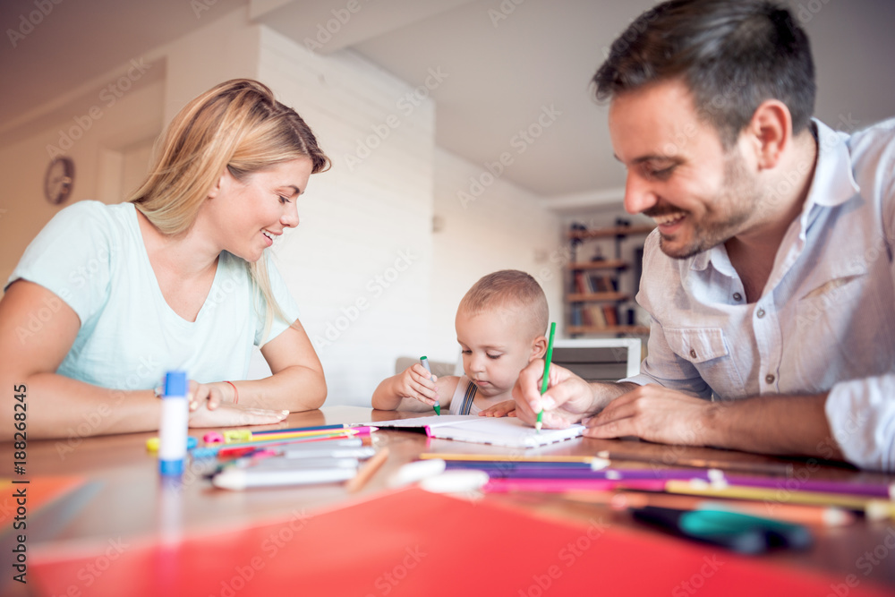 Young parents with young child draw. Young parents with young child draw.
