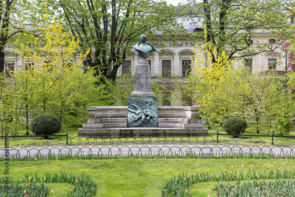Obraz premium Statue of Artur Grottger in the Planty Park, Krakow, Poland
