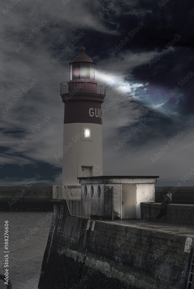 Night shot with lighthouse near the entrance of the main harbor LeGuilvinec, Brittany, France