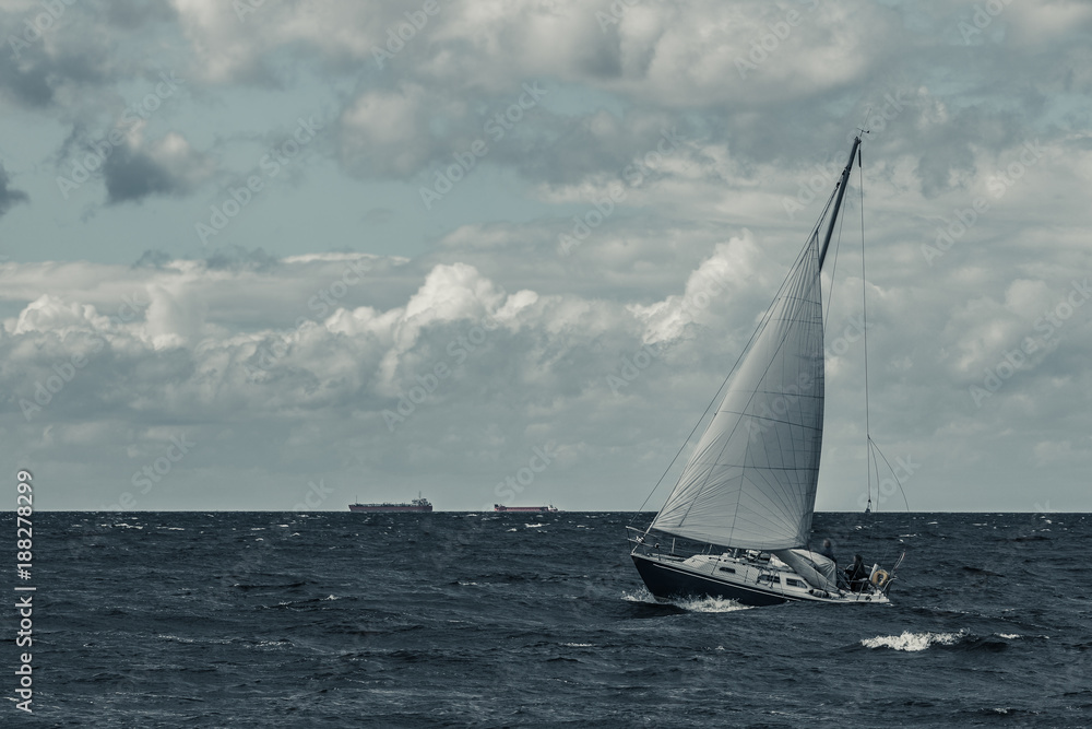 Blue sailboat at storm