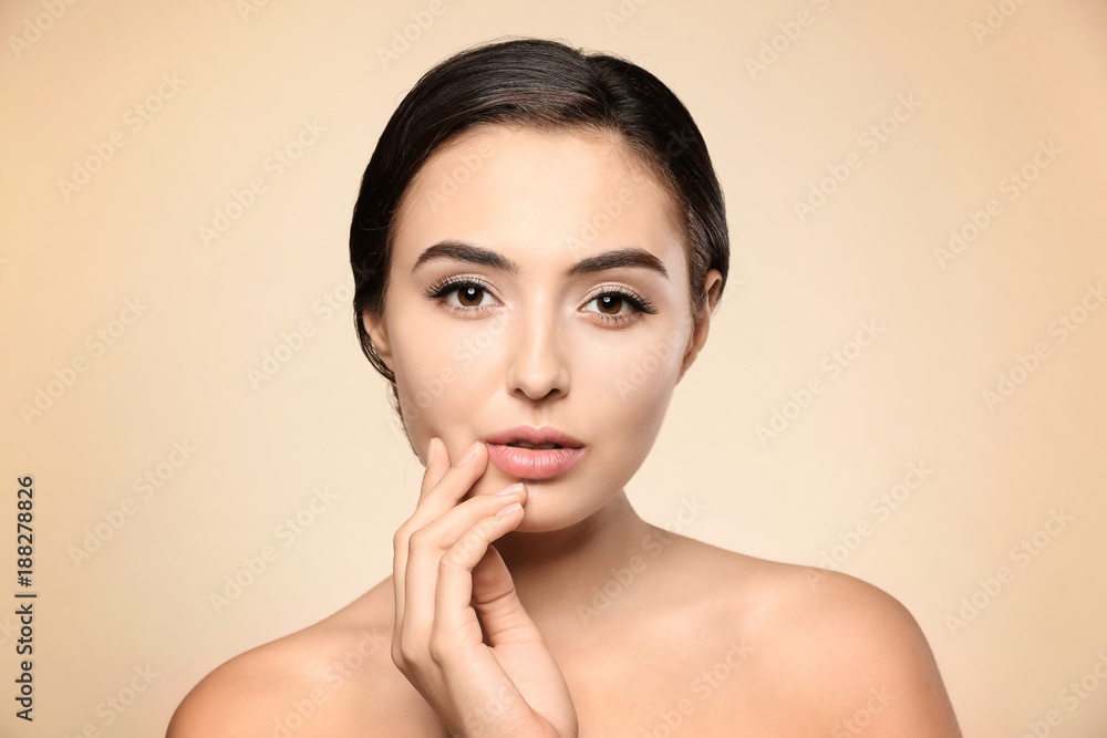Beautiful young woman with eyelash extensions on color background Beautiful young woman with eyelash extensions on color background