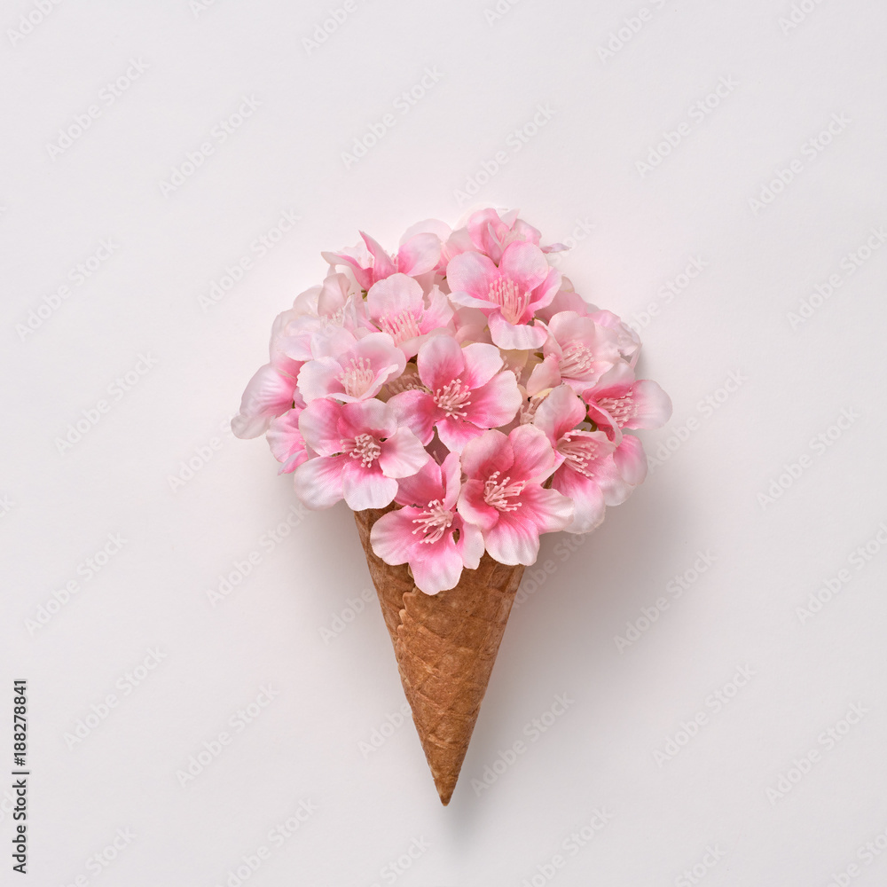 Fototapeta Ice Cream Cone with Bouquet of Flowers. Spring Summer Floral concept. Creative Minimal. Pink Blossom, Vanilla Color. Trendy fashion Style. Art