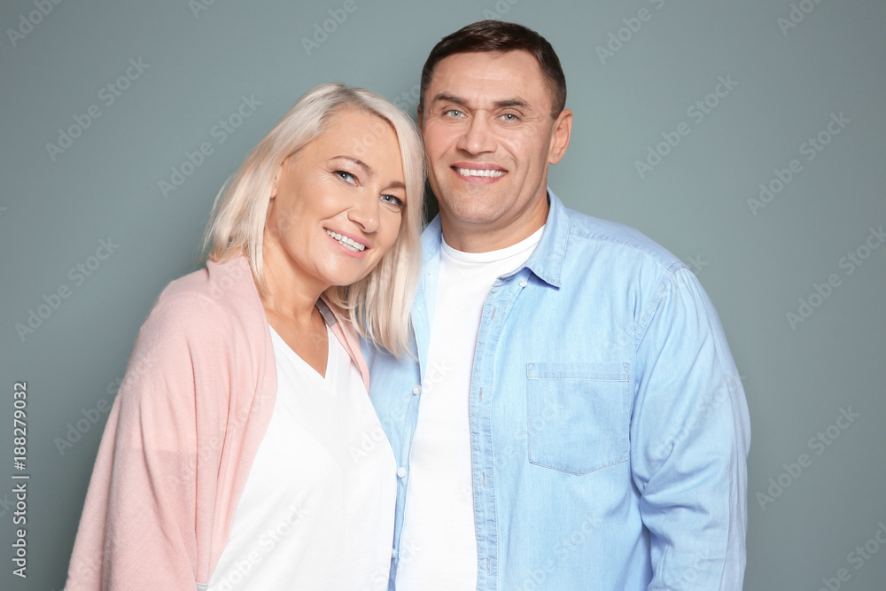 Cute middle-aged couple on color background Cute middle-aged couple on color background