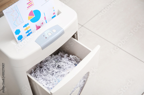 Destroying document with shredder in office