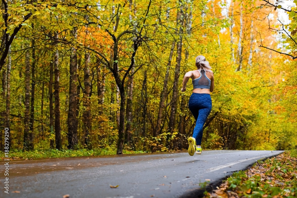 Woman running in the autumn park
