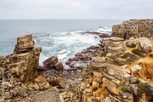 View of nice cliff and sea on the back, rocky ocean shore photo